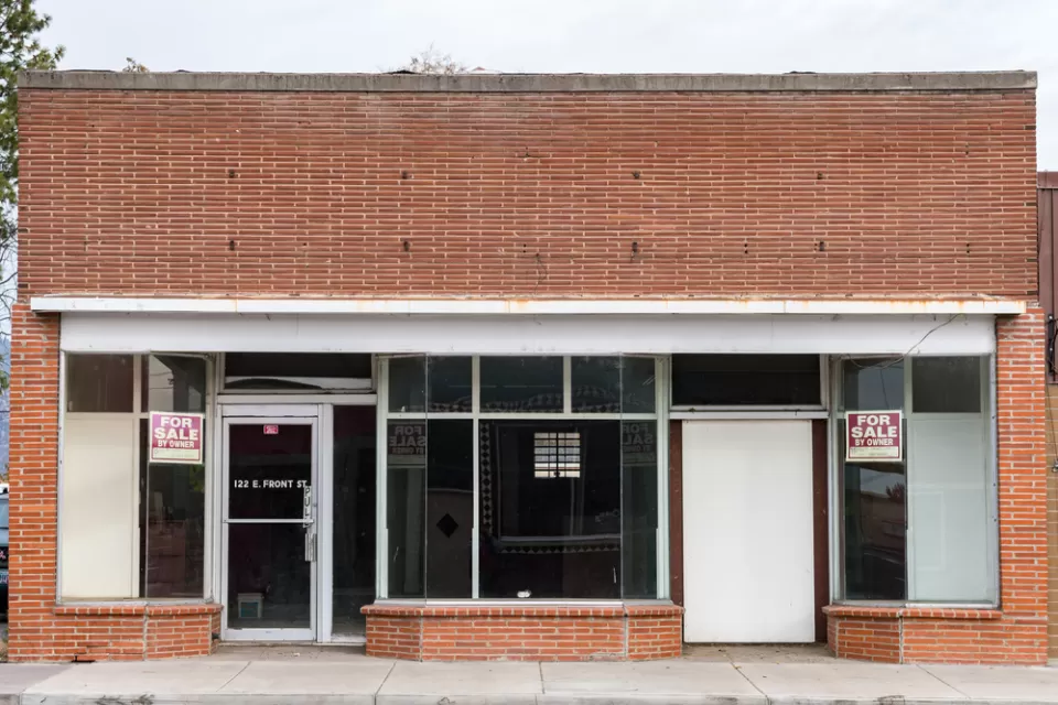 Line of vacant small storefronts with For Sale signs in Merrill, Oregon